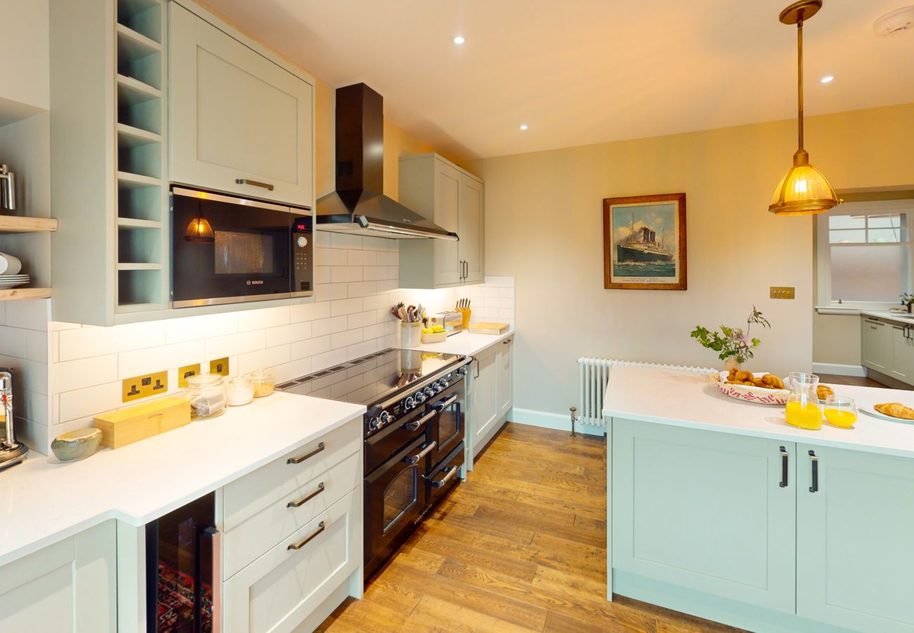Open plan kitchen with dining space and large windows at Lynwilg House Highland self-catering home