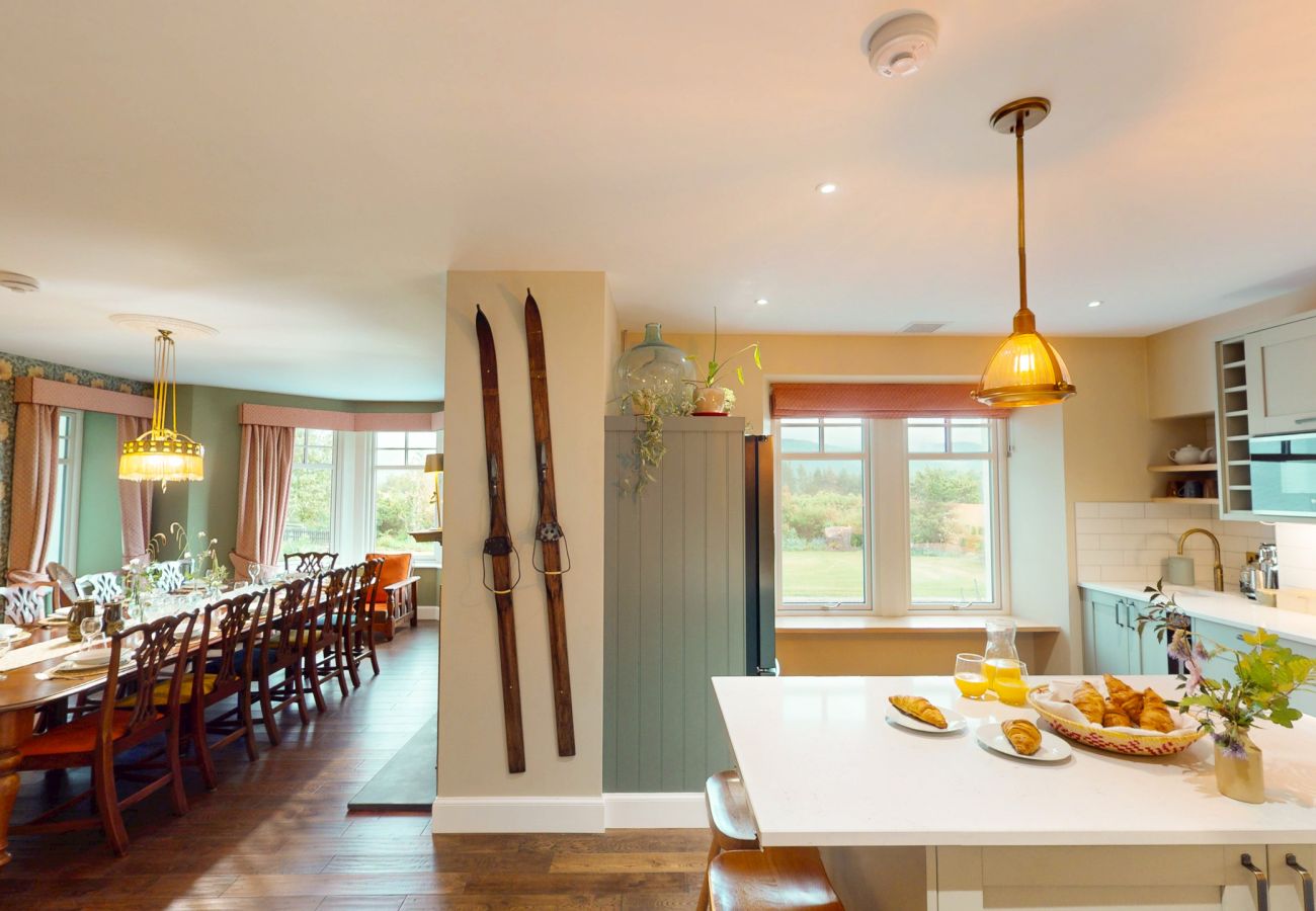 Long dining table seating large groups in the elegant dining room at Lynwilg House Highland holiday home