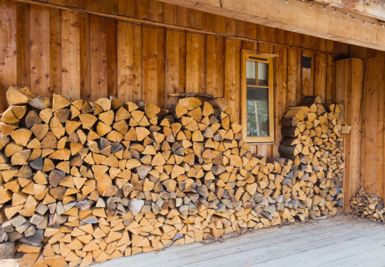 Firewood stacked along the timber wall outside Wildcat Lodge near Boat of Garten, Cairngorms
