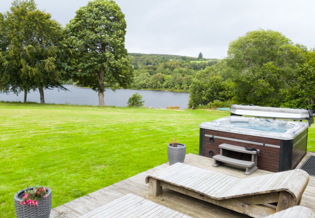 Hot tub and lawn looking out towards the loch through the trees at Kinloch Lodge, Balnain near Drumnadrochit