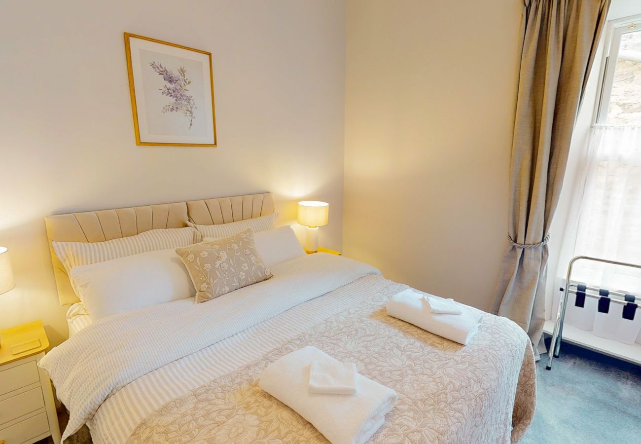 Second double bedroom with bedside lamp and clothes rail at Twinflower townhouse, Grantown-on-Spey